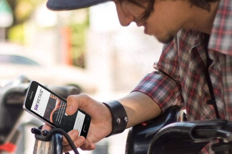 Toerist op publieke fiets bekijkt voorbeeld webshop op mobiel